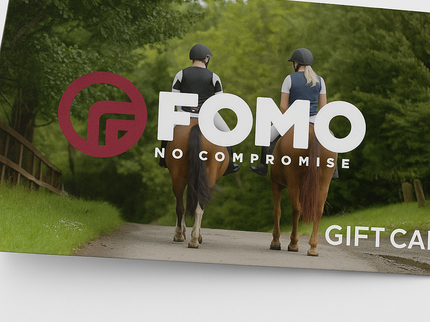 FOMO gift card with two people riding horses on a path in a forest.