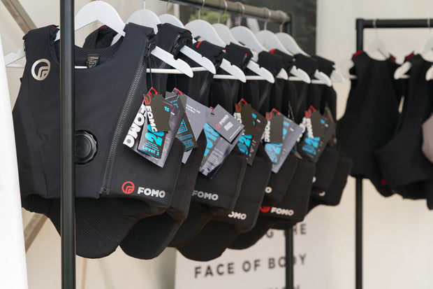Black Body Protectors with brand logos hanging on a rack